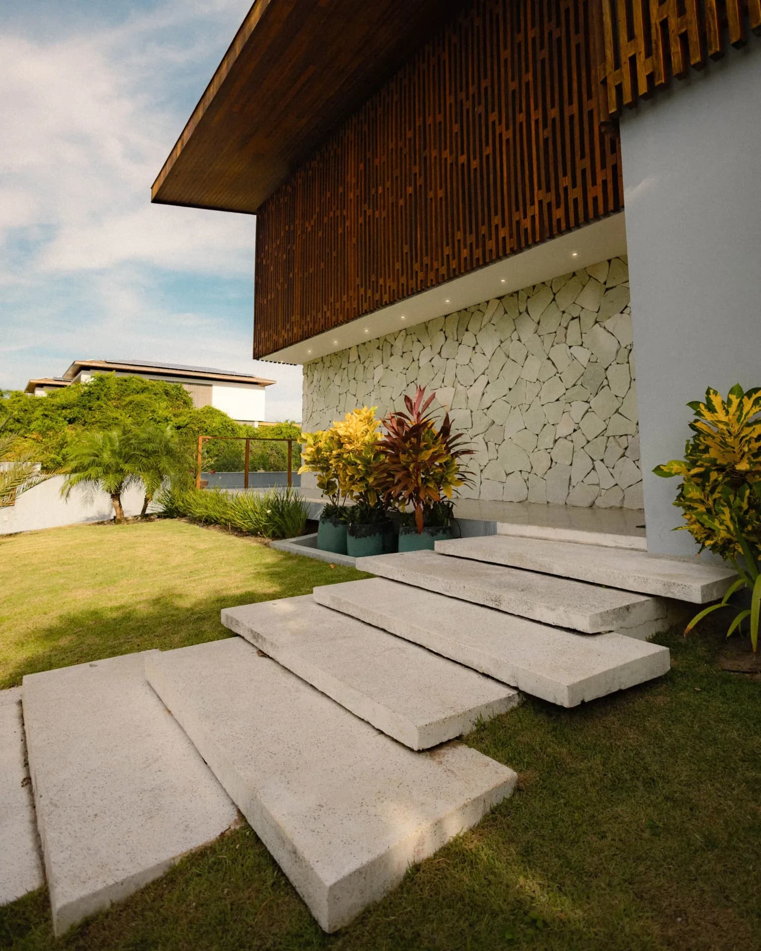 Newly poured concrete stairs leading to a front door